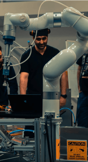 Bahador Moineddini working with a collaborative robot arm